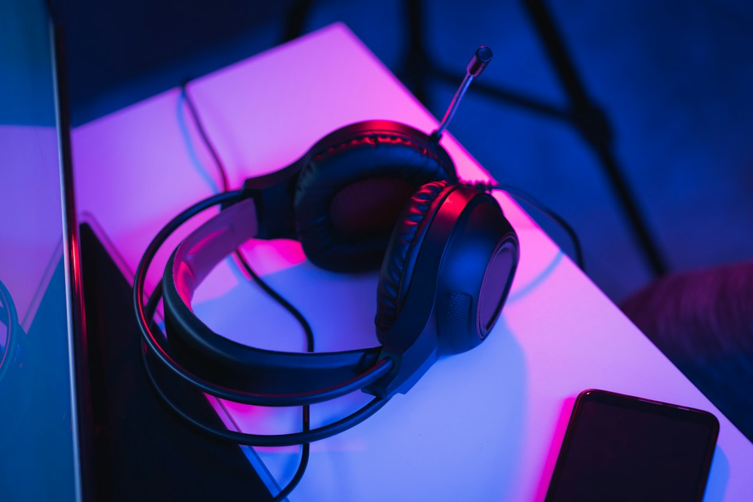 Gaming headset on a desk under purple and blue light, illustrating MP3 to OGG conversion for game audio