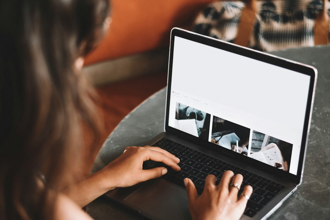 Person typing on a laptop with a web page open in the browser, the usual source of WebM recordings to convert to MP4